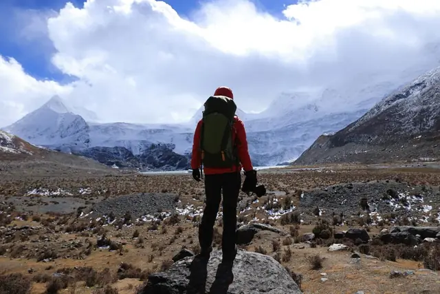 An explorer looking across a mountain landscape